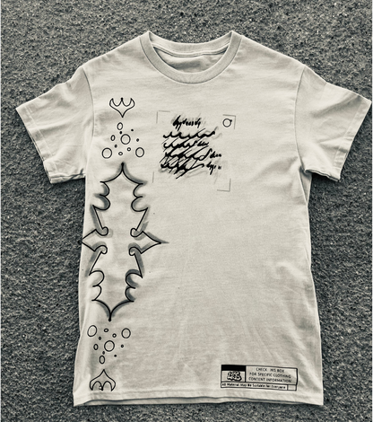 White t-shirt with black graphic design on a textured gray surface